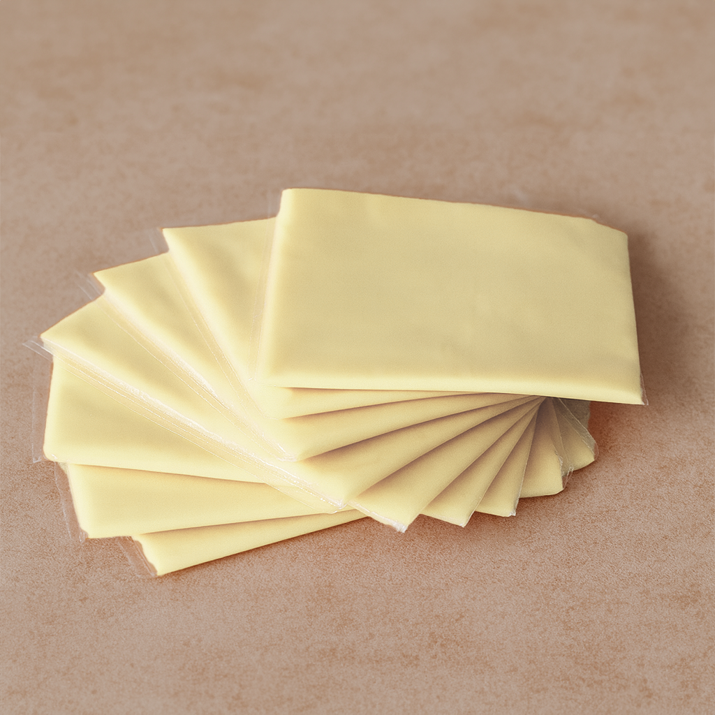 White cheddar cheese slices for burgers and sandwiches – smooth and creamy, available in Lahore
