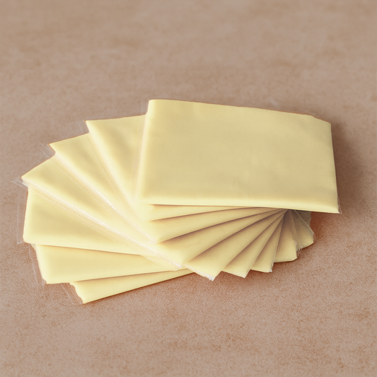White cheddar cheese slices for burgers and sandwiches – smooth and creamy, available in Lahore
